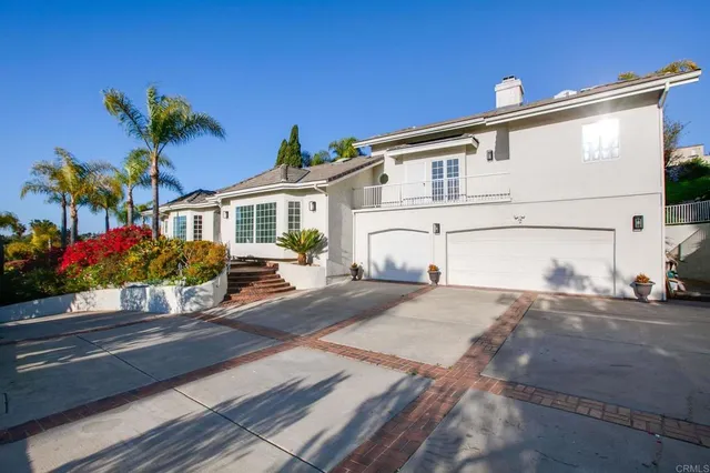 a front view of a house with a yard and a garage