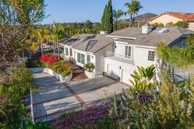 a backyard of a house with lots of green space and trees all around