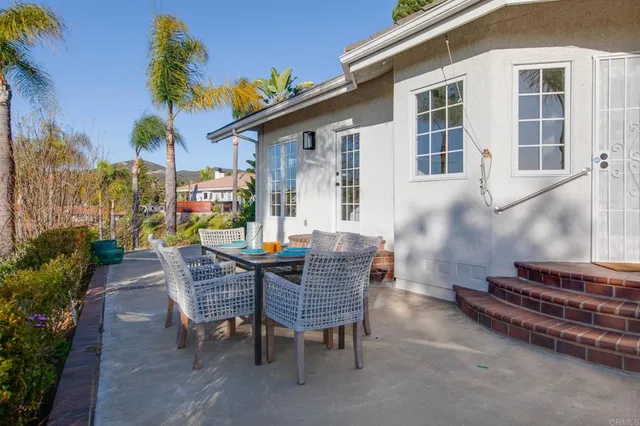 a view of a house with backyard and sitting area