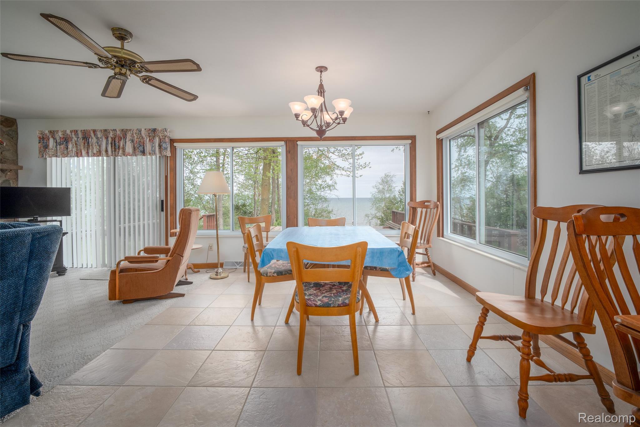 6240 Lakeshore Road Palms, MI 48465 - Photo 8 of 38 Dining space featuring a chandelier, plenty of natural light, ceiling fan, and light carpet
