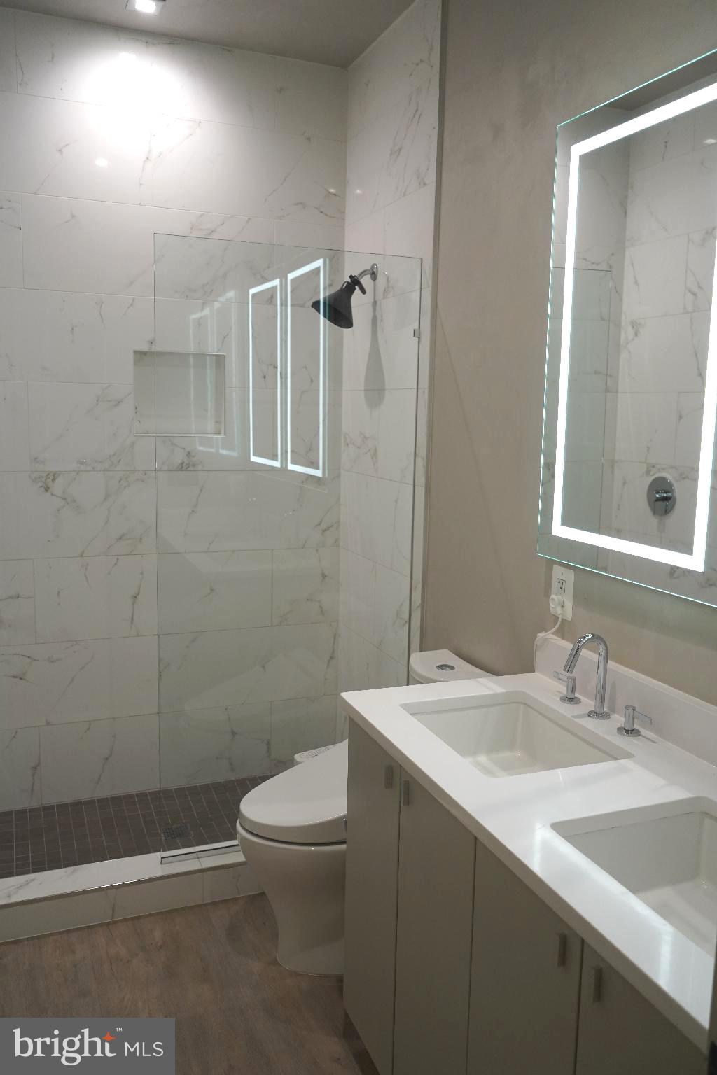 725 Euclid Street Northwest, Unit 2 Washington, DC 20001 - Photo 8 of 14 a bathroom with a sink a toilet and shower