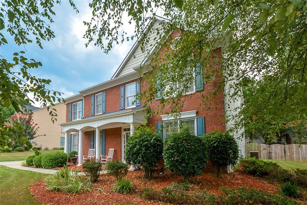 1232 Fieldcrest Court Suwanee, GA 30024 - Photo 1 of 1 a front view of a house with plants and trees