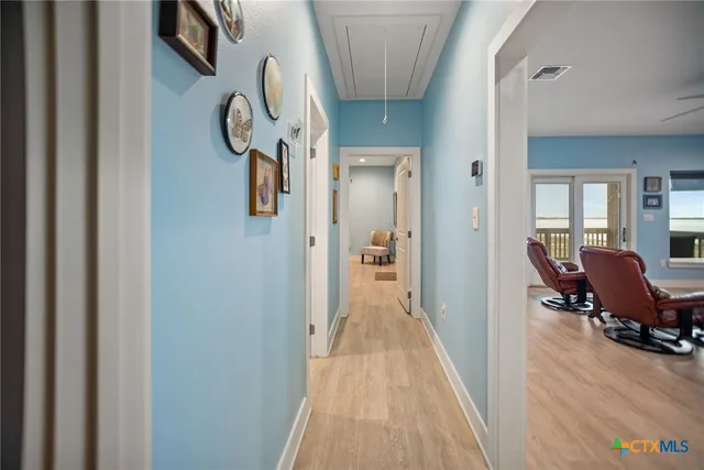 a view of a hallway to a livingroom and a dinning area with furniture
