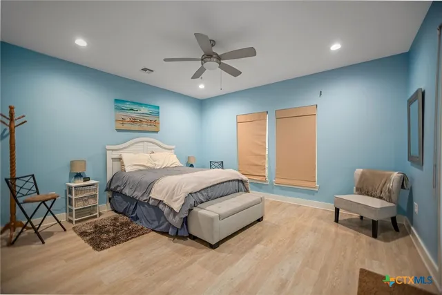 a spacious bedroom with a bed and a couch