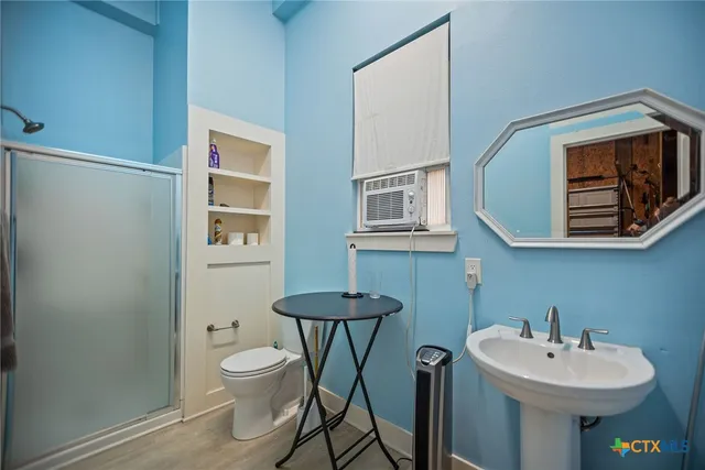 a bathroom with a sink toilet and mirror