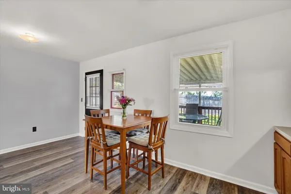 a view of a dining room with furniture and window