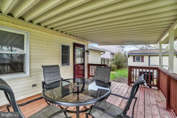 a outdoor dining space with furniture and wooden floor