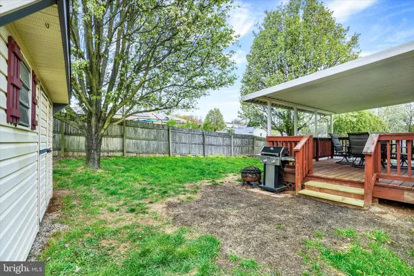 a view of backyard with sitting area