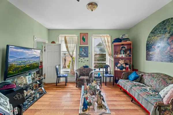 a room with furniture a rug toys and a window
