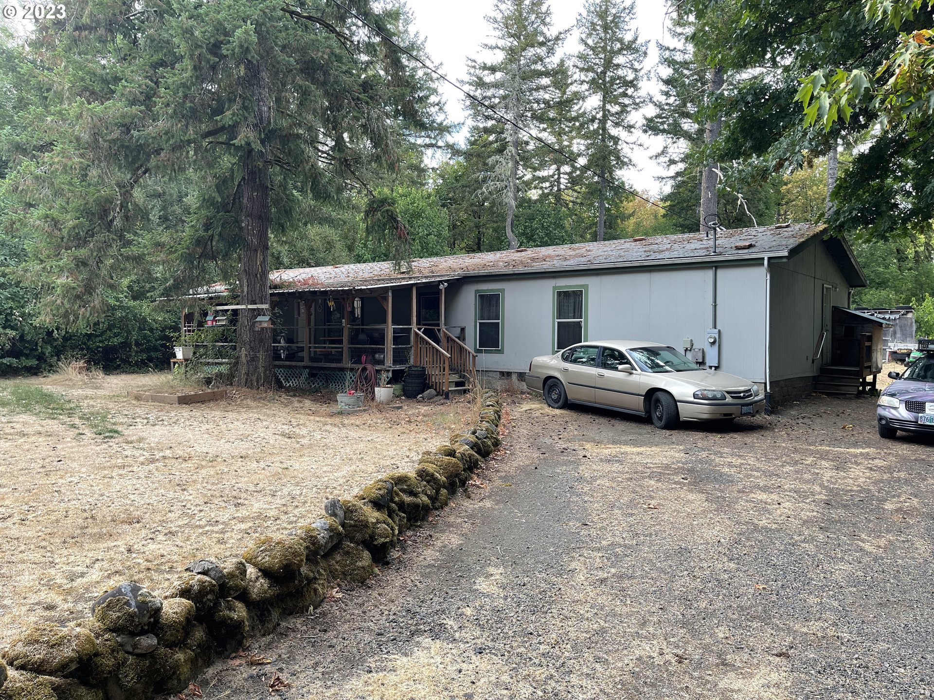 8295 King Road Grand Ronde, OR 97347 - Photo 1 of 32 a couple of cars parked in front of a house