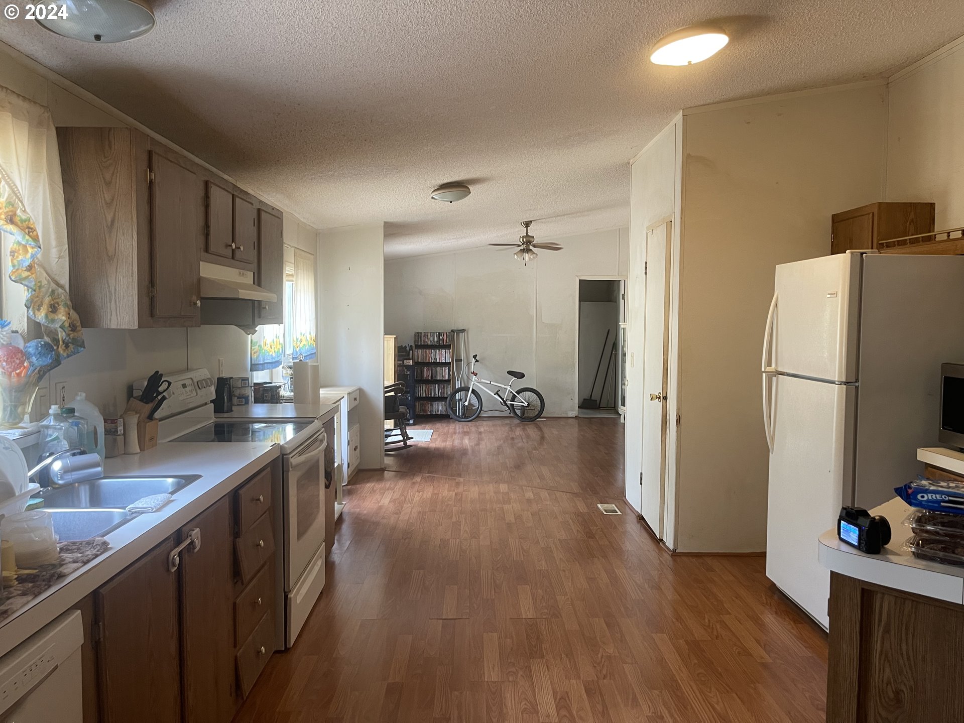 8295 King Road Grand Ronde, OR 97347 - Photo 16 of 32 a kitchen with stainless steel appliances a refrigerator sink and wooden floor