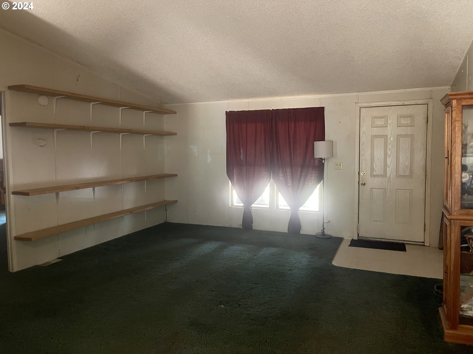 8295 King Road Grand Ronde, OR 97347 - Photo 17 of 32 a view of empty room with wooden floor and cabinet