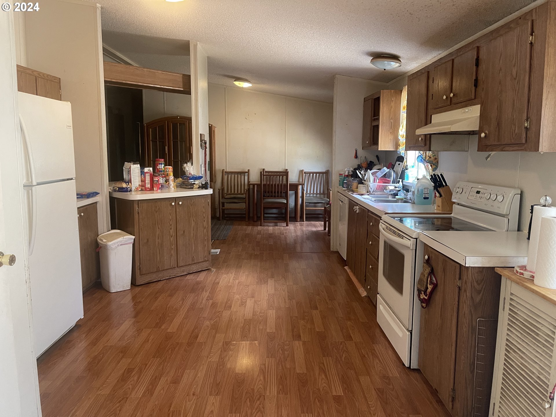 8295 King Road Grand Ronde, OR 97347 - Photo 19 of 32 a kitchen with sink cabinets and wooden floor
