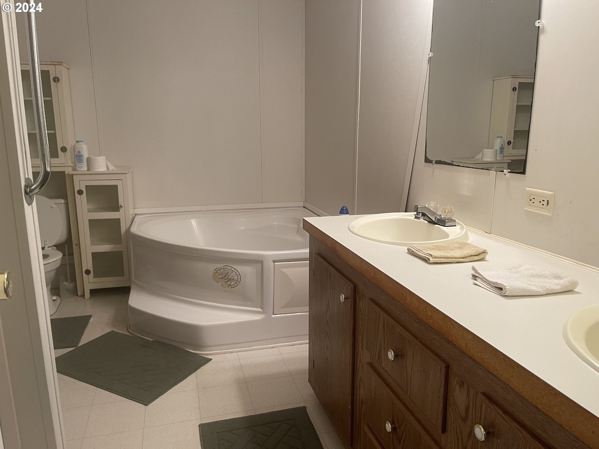 8295 King Road Grand Ronde, OR 97347 - Photo 23 of 32 a bathroom with a sink and a mirror