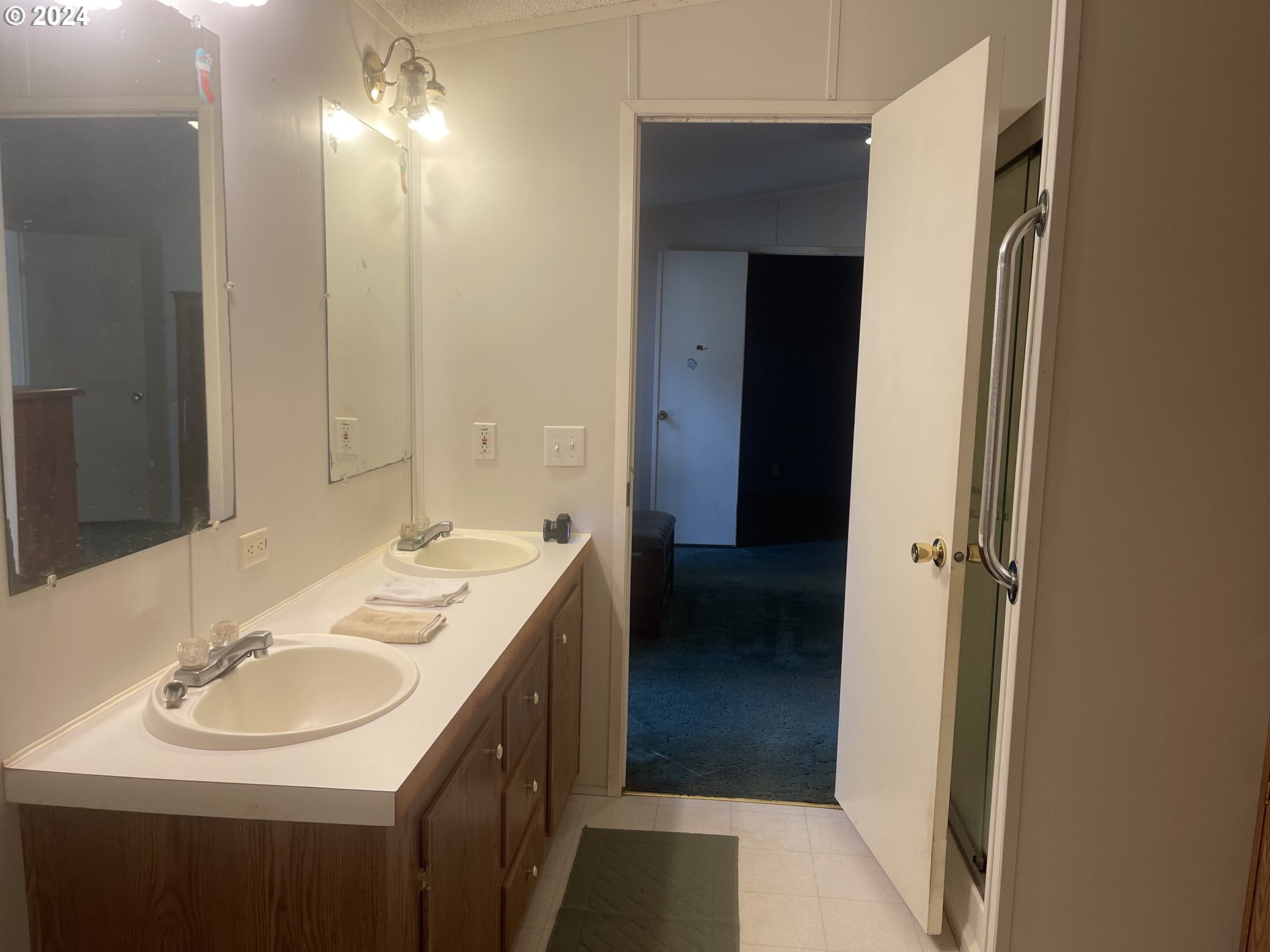 8295 King Road Grand Ronde, OR 97347 - Photo 25 of 32 a bathroom with a sink and a mirror