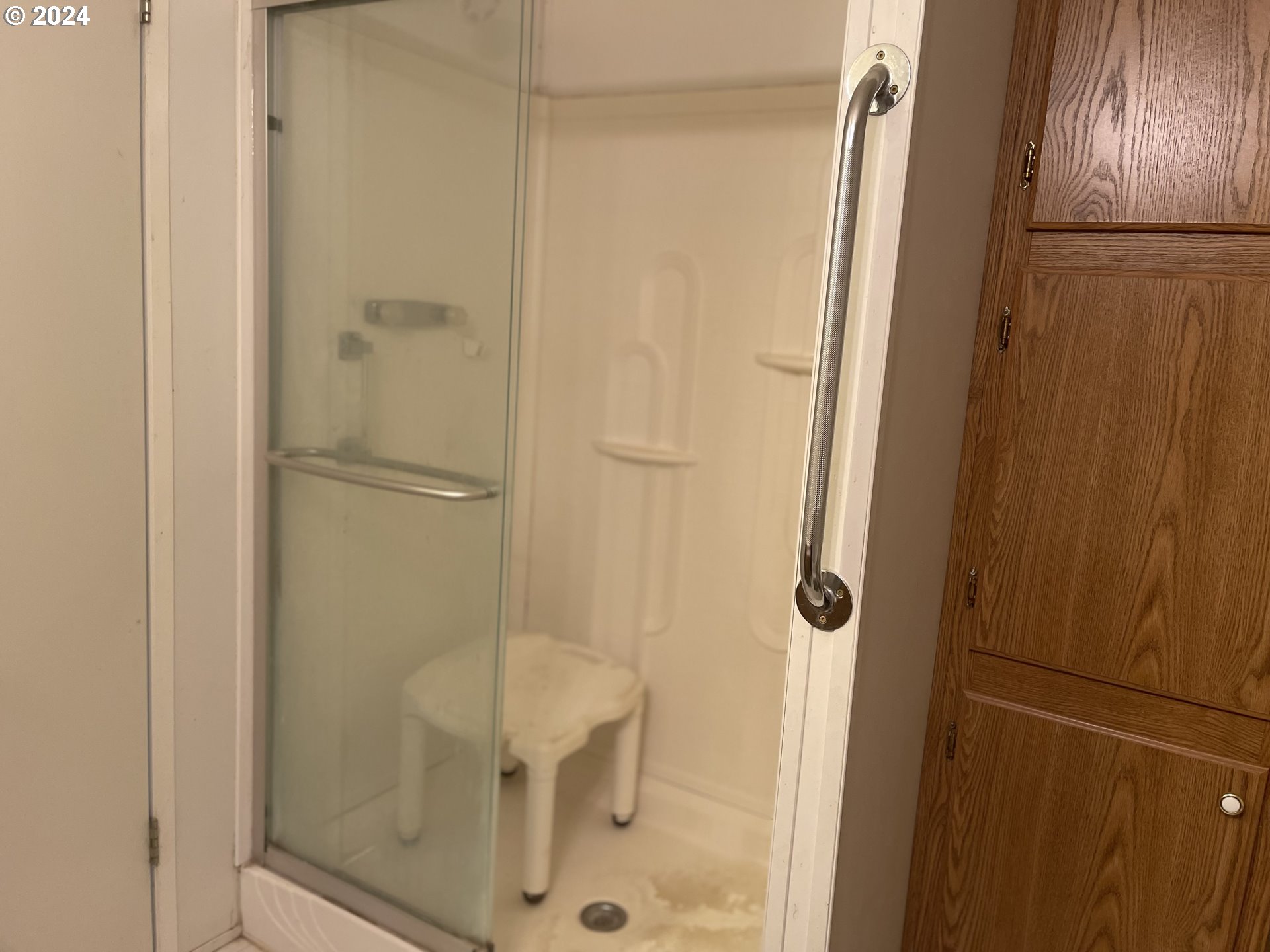 8295 King Road Grand Ronde, OR 97347 - Photo 26 of 32 a bathroom with a glass shower door