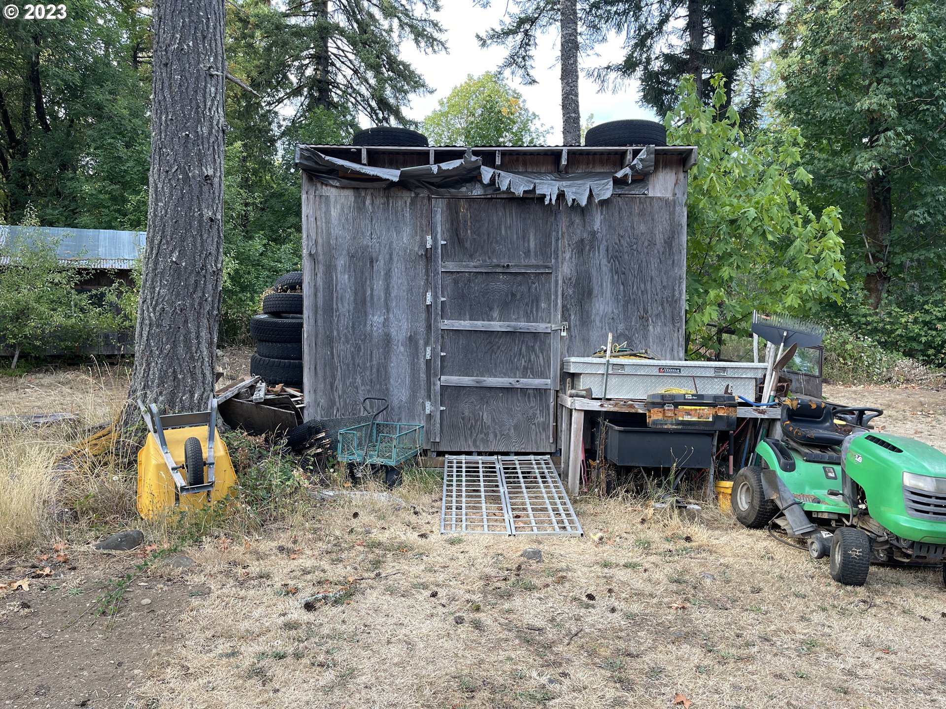 8295 King Road Grand Ronde, OR 97347 - Photo 4 of 32 a backyard of a house with barbeque oven table and chairs