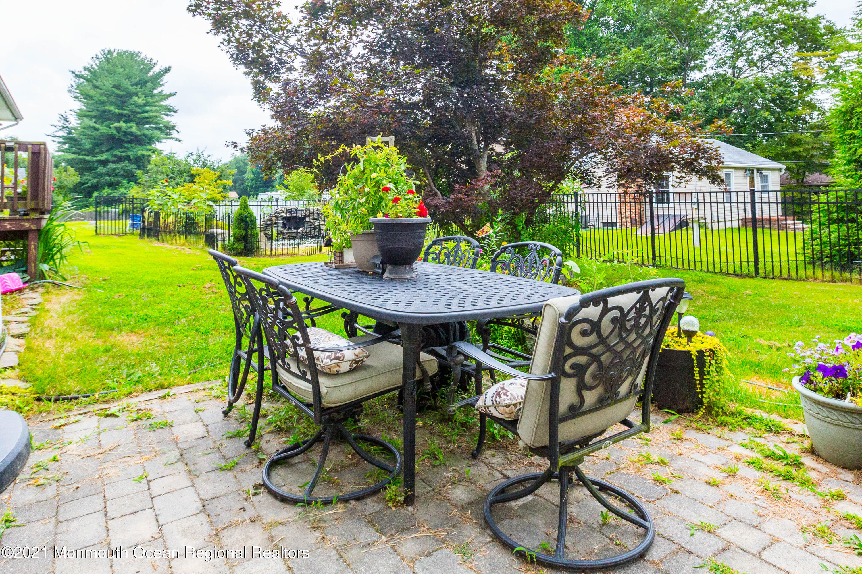 544 Brickyard Road Freehold, NJ 07728 - Photo 19 of 24 a view of a backyard with furniture and a garden