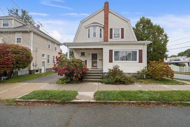 a front view of a house with a yard and a garage