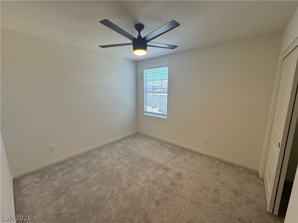 2821 Alcobaca Street Henderson, NV 89044 - Photo 15 of 24 A well-lit bedroom features plush carpeting and a modern ceiling fan for year-round comfort.