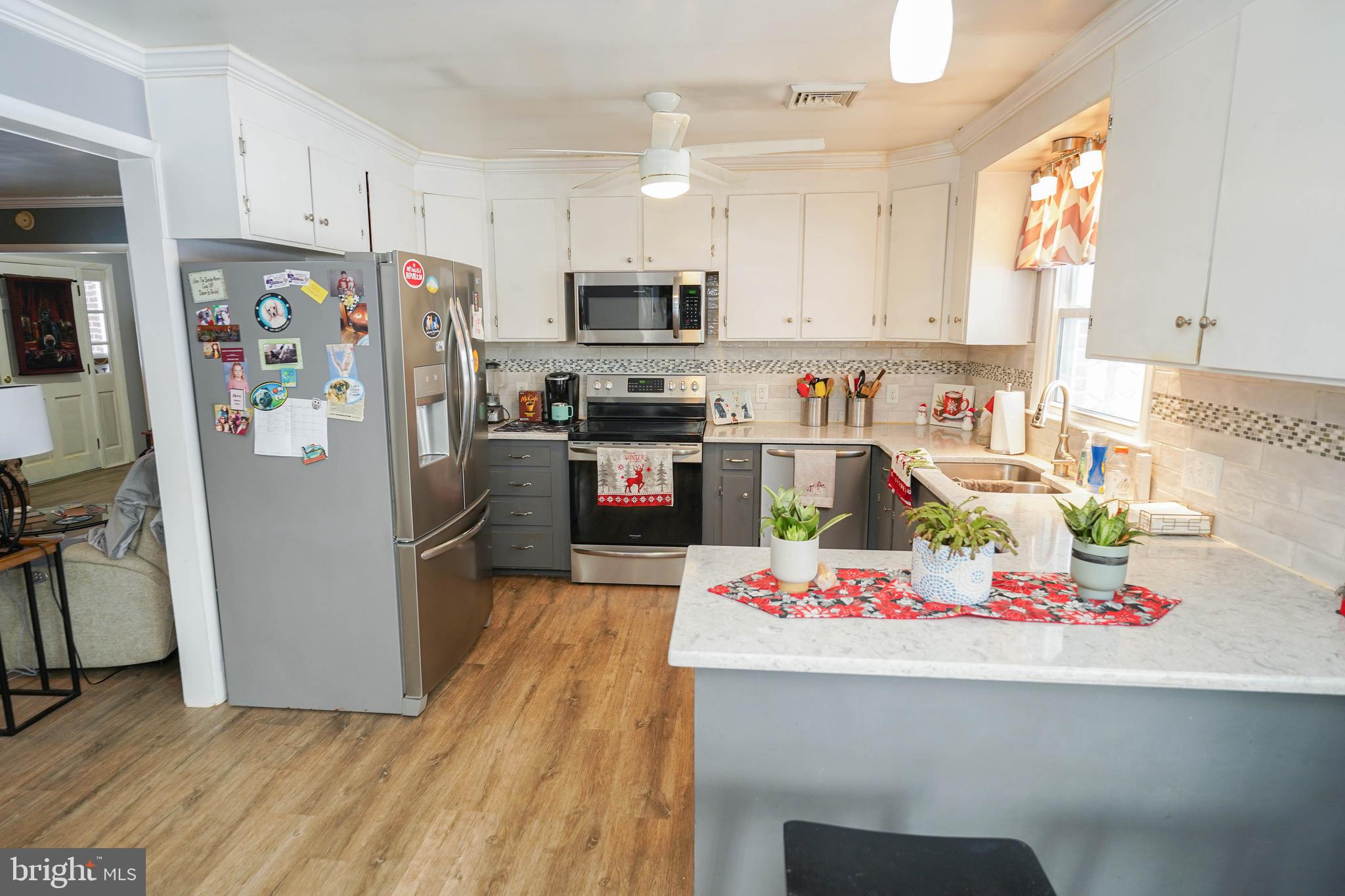 5627 Galestown Reliance Road Rhodesdale, MD 21659 - Photo 11 of 48 a kitchen with refrigerator a stove a sink dishwasher and wooden floor