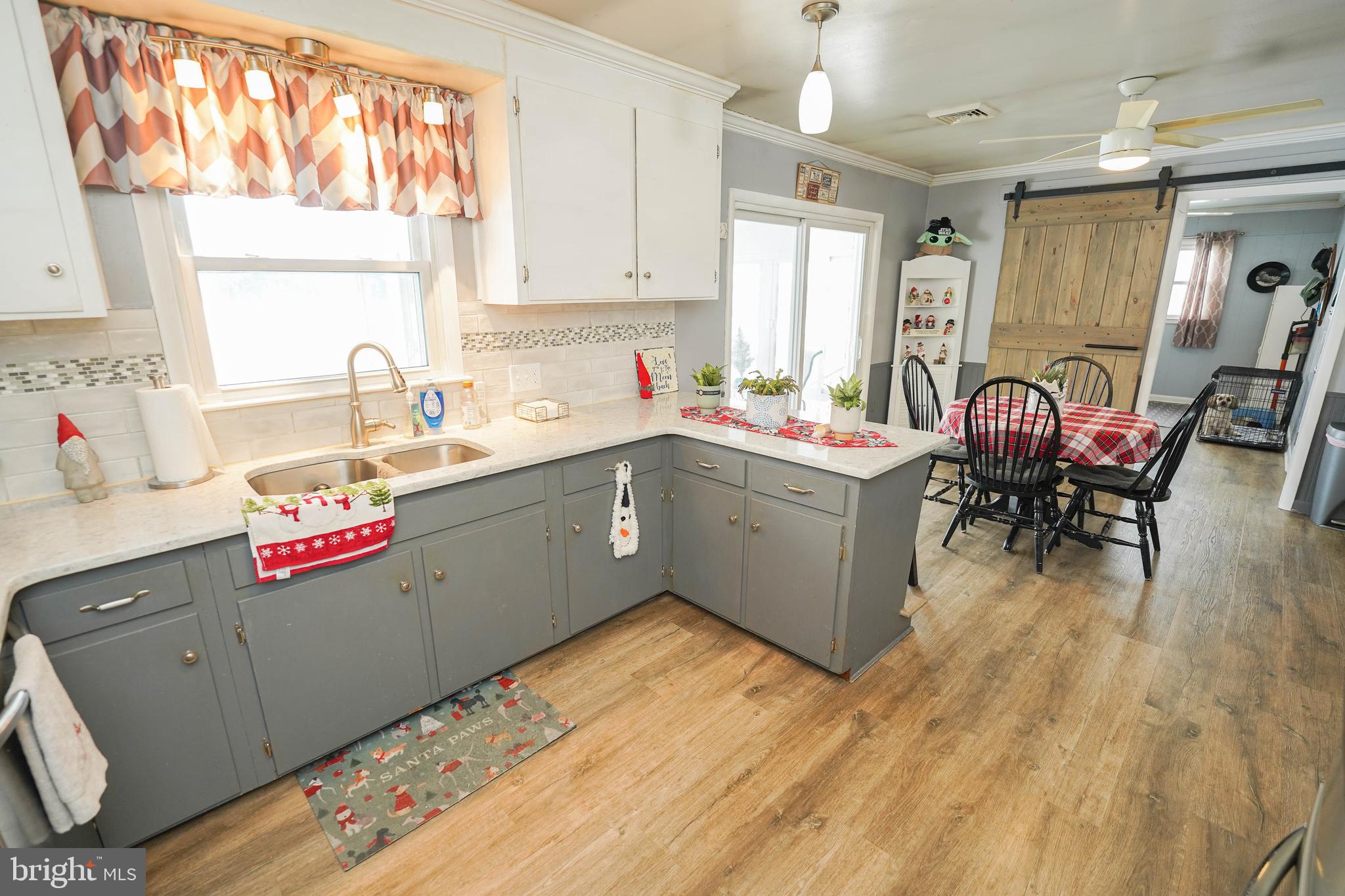 5627 Galestown Reliance Road Rhodesdale, MD 21659 - Photo 14 of 48 a kitchen with a sink cabinets and wooden floor