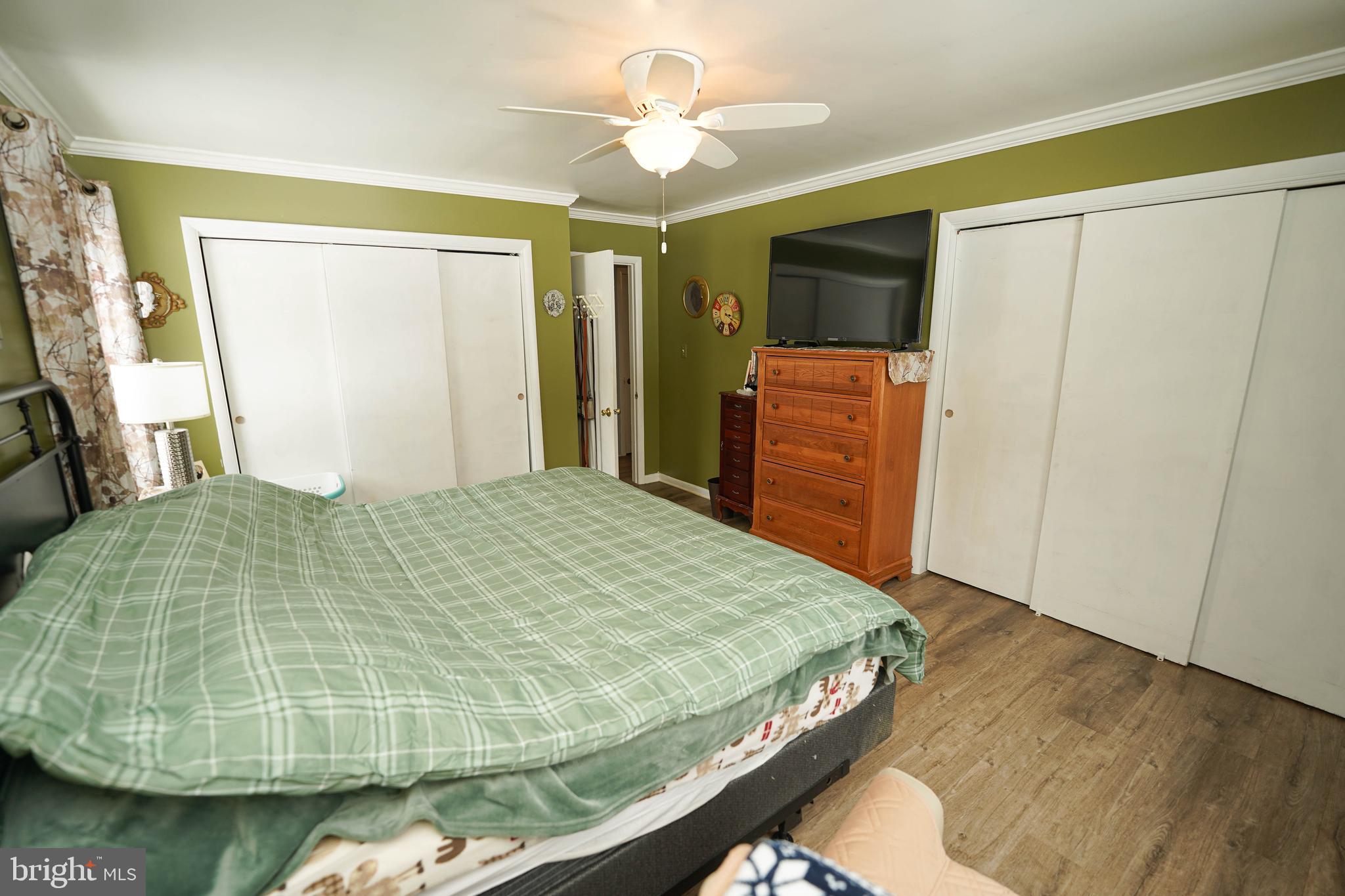 5627 Galestown Reliance Road Rhodesdale, MD 21659 - Photo 31 of 48 a bedroom with a bed and a flat tv screen on dresser