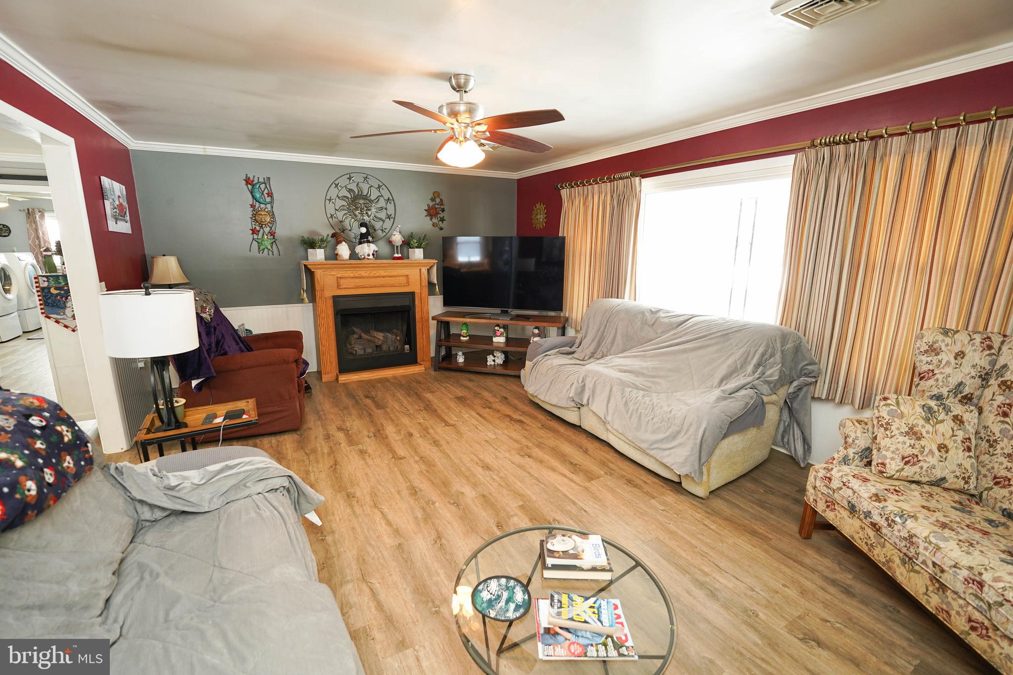 5627 Galestown Reliance Road Rhodesdale, MD 21659 - Photo 7 of 48 a spacious bedroom with a bed and a fireplace