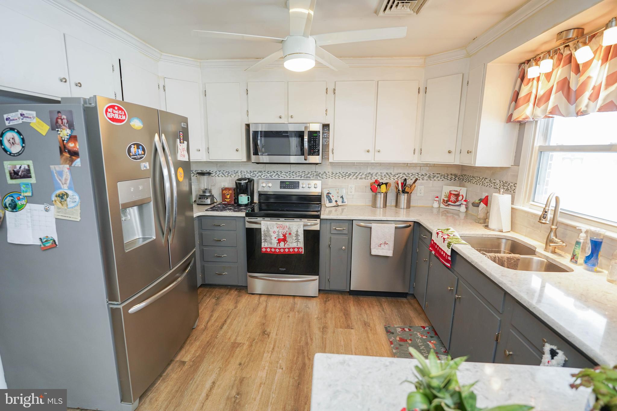 5627 Galestown Reliance Road Rhodesdale, MD 21659 - Photo 10 of 48 a kitchen with stainless steel appliances a refrigerator sink and wooden cabinets