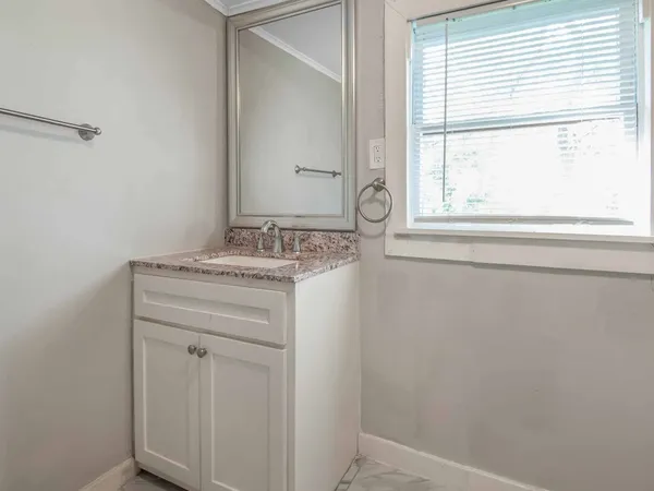 a bathroom with a sink and a window