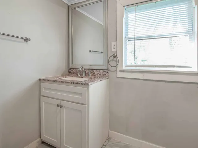 a bathroom with a sink and a window