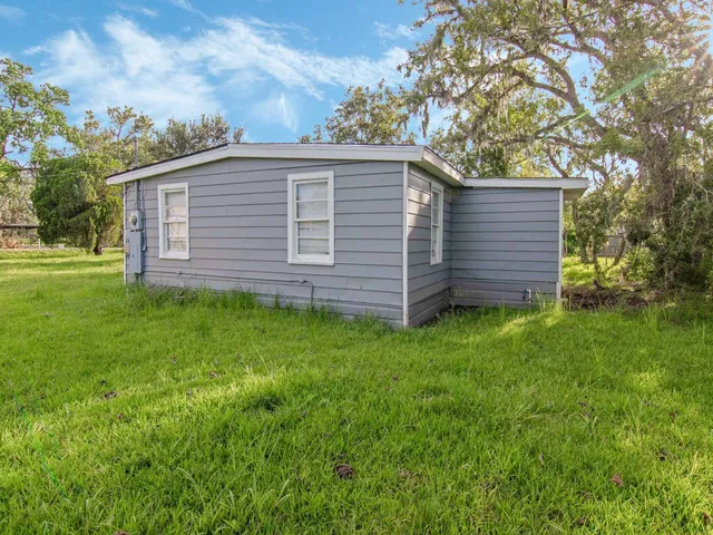 a view of a house with a backyard