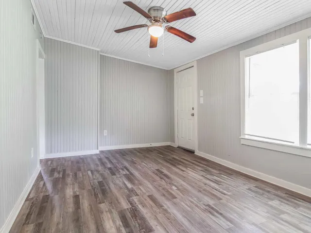 wooden floor in an empty room with a window
