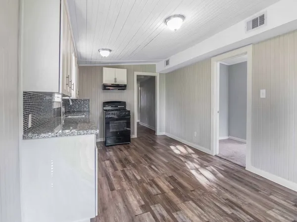 a view of a kitchen with a sink and a refrigerator