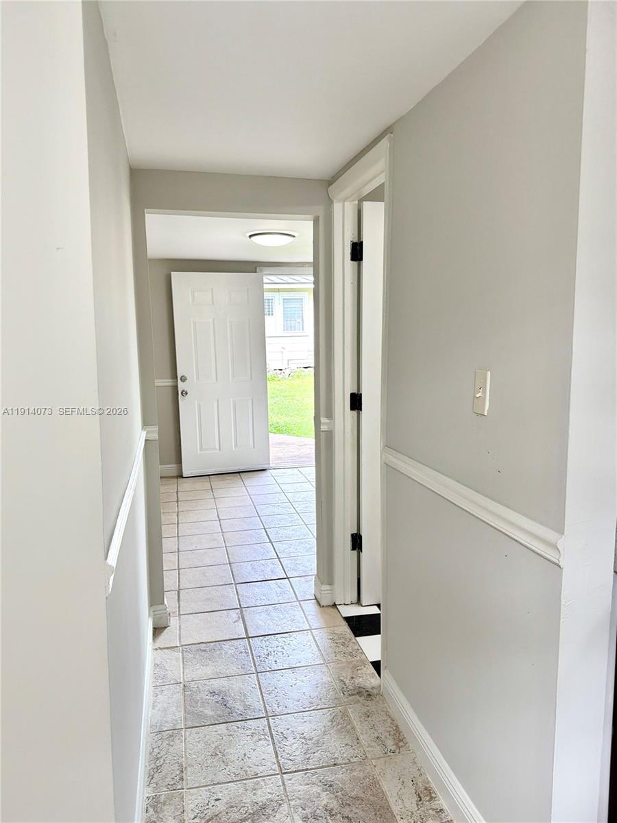 a view of an empty room and a window