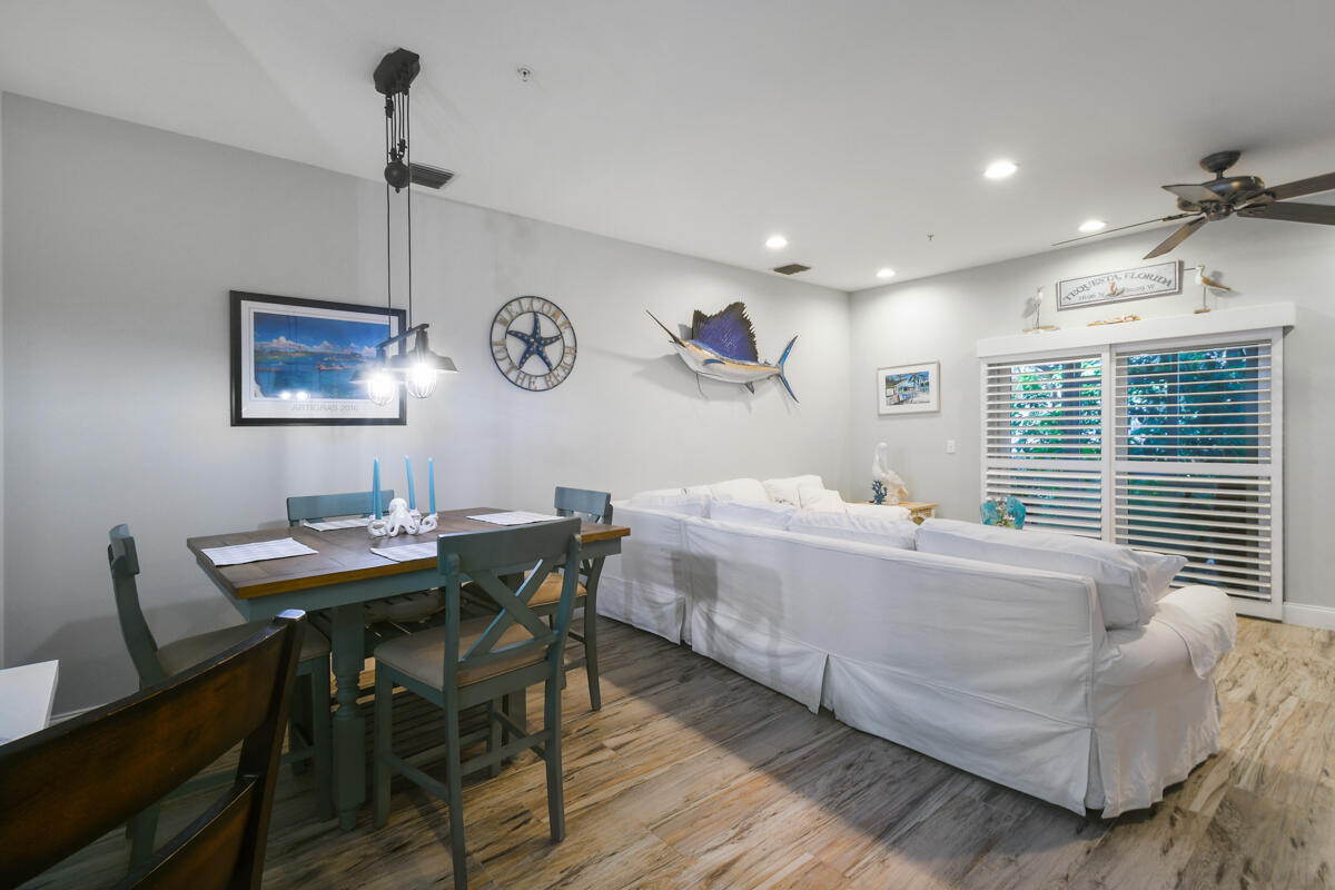 105 Lighthouse Circle, Unit D Tequesta, FL 33469 - Photo 11 of 36 a living room with furniture a window and a table