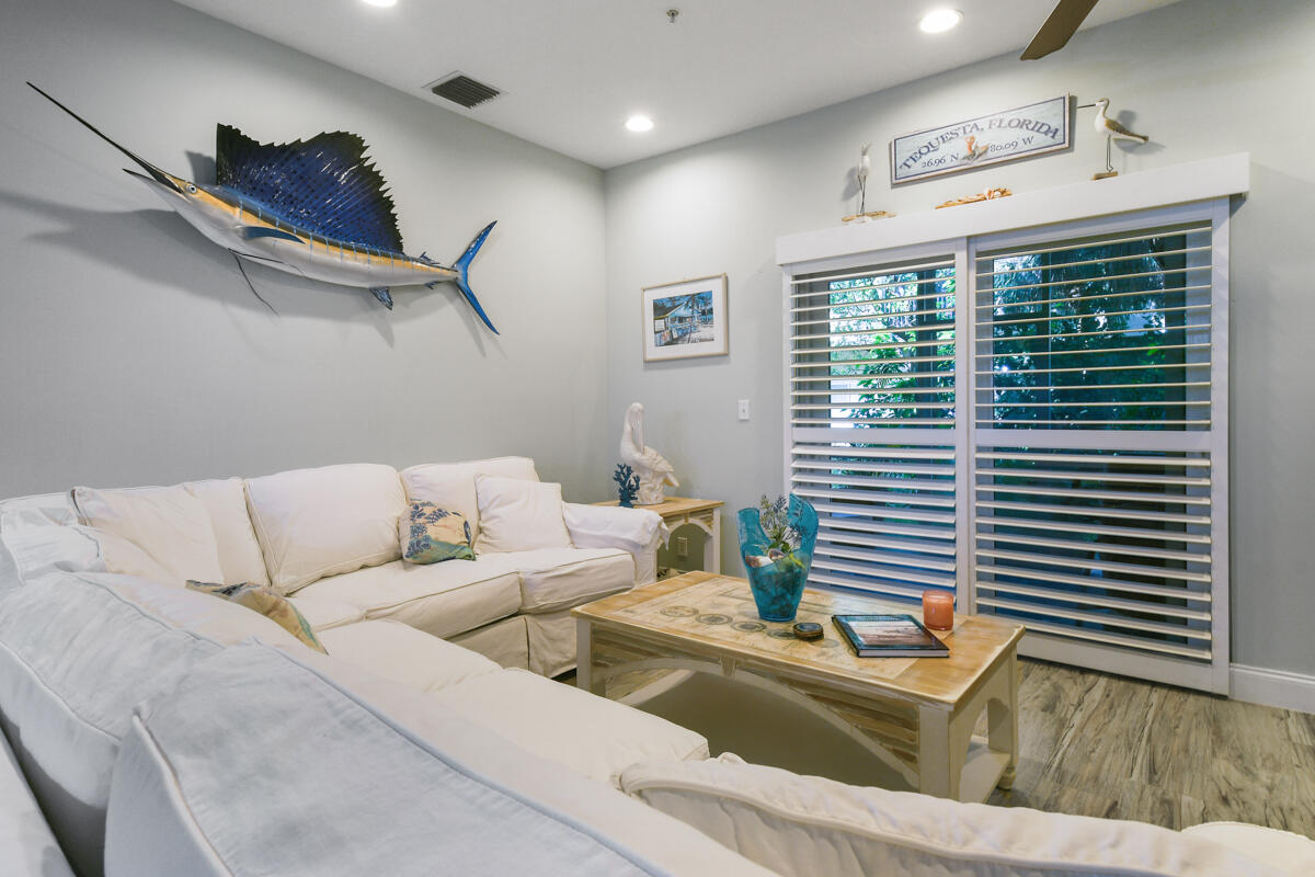 105 Lighthouse Circle, Unit D Tequesta, FL 33469 - Photo 12 of 36 a living room with furniture and a window