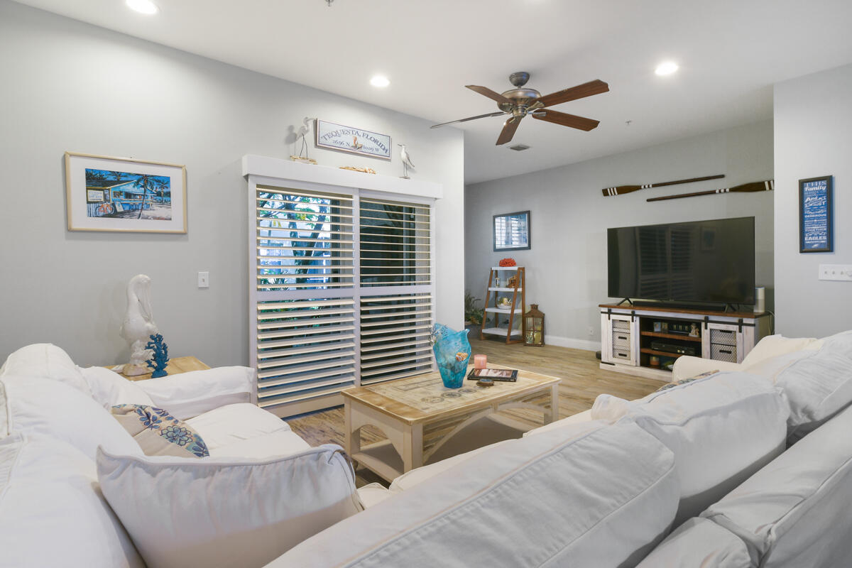 105 Lighthouse Circle, Unit D Tequesta, FL 33469 - Photo 13 of 36 a living room with furniture and a flat screen tv