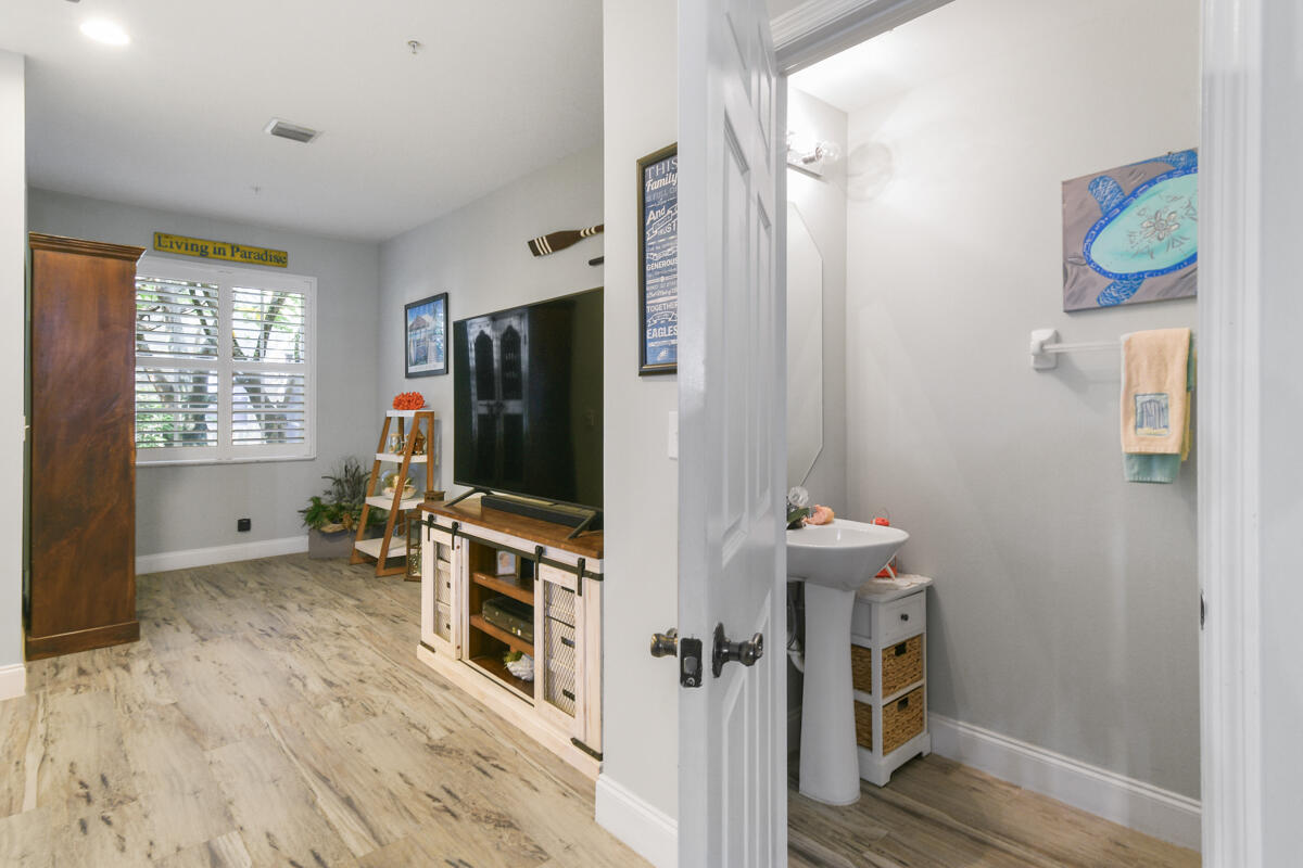 105 Lighthouse Circle, Unit D Tequesta, FL 33469 - Photo 16 of 36 a living room with furniture and a flat screen tv