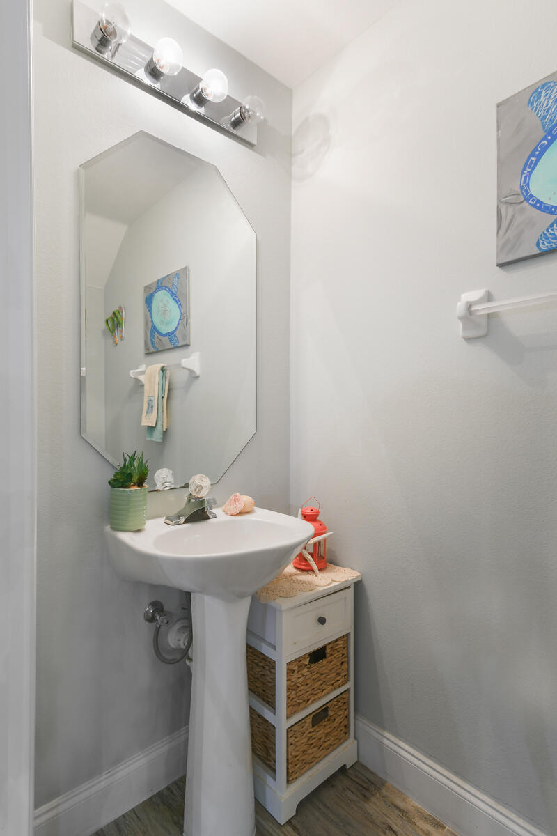105 Lighthouse Circle, Unit D Tequesta, FL 33469 - Photo 17 of 36 a bathroom with a sink and a mirror