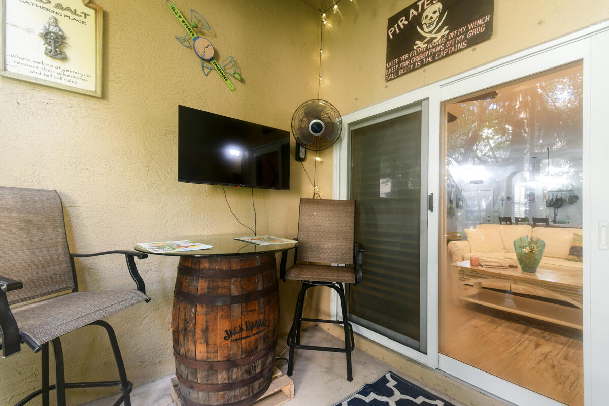 105 Lighthouse Circle, Unit D Tequesta, FL 33469 - Photo 19 of 36 a living room with furniture and a flat screen tv