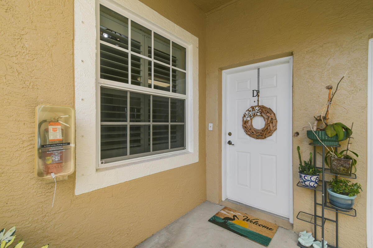 105 Lighthouse Circle, Unit D Tequesta, FL 33469 - Photo 23 of 36 a view of an empty room with a window and potted plants