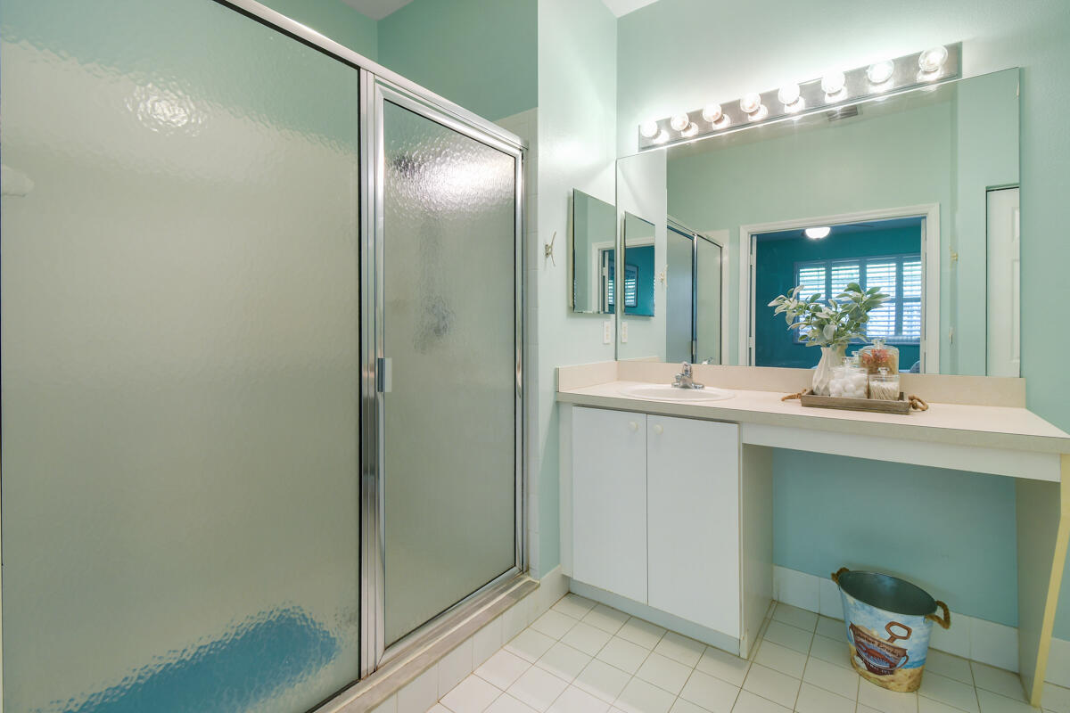 105 Lighthouse Circle, Unit D Tequesta, FL 33469 - Photo 28 of 36 a bathroom with a double vanity sink and a mirror