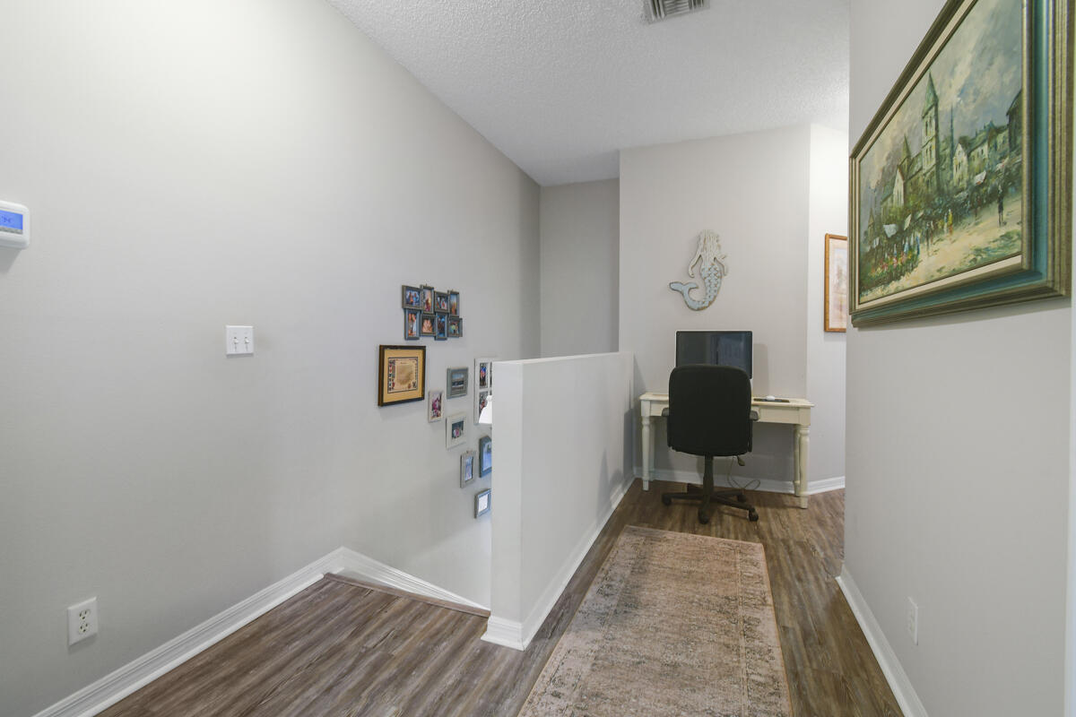 105 Lighthouse Circle, Unit D Tequesta, FL 33469 - Photo 30 of 36 a view of a hallway with workspace and wooden floor