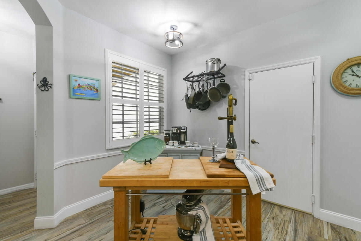 105 Lighthouse Circle, Unit D Tequesta, FL 33469 - Photo 35 of 36 a room with a table and a chandelier