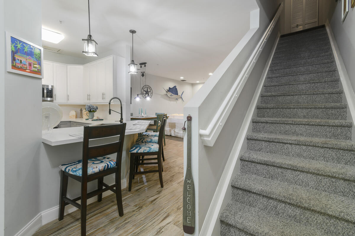 105 Lighthouse Circle, Unit D Tequesta, FL 33469 - Photo 36 of 36 a view of a dining room with furniture and wooden floor