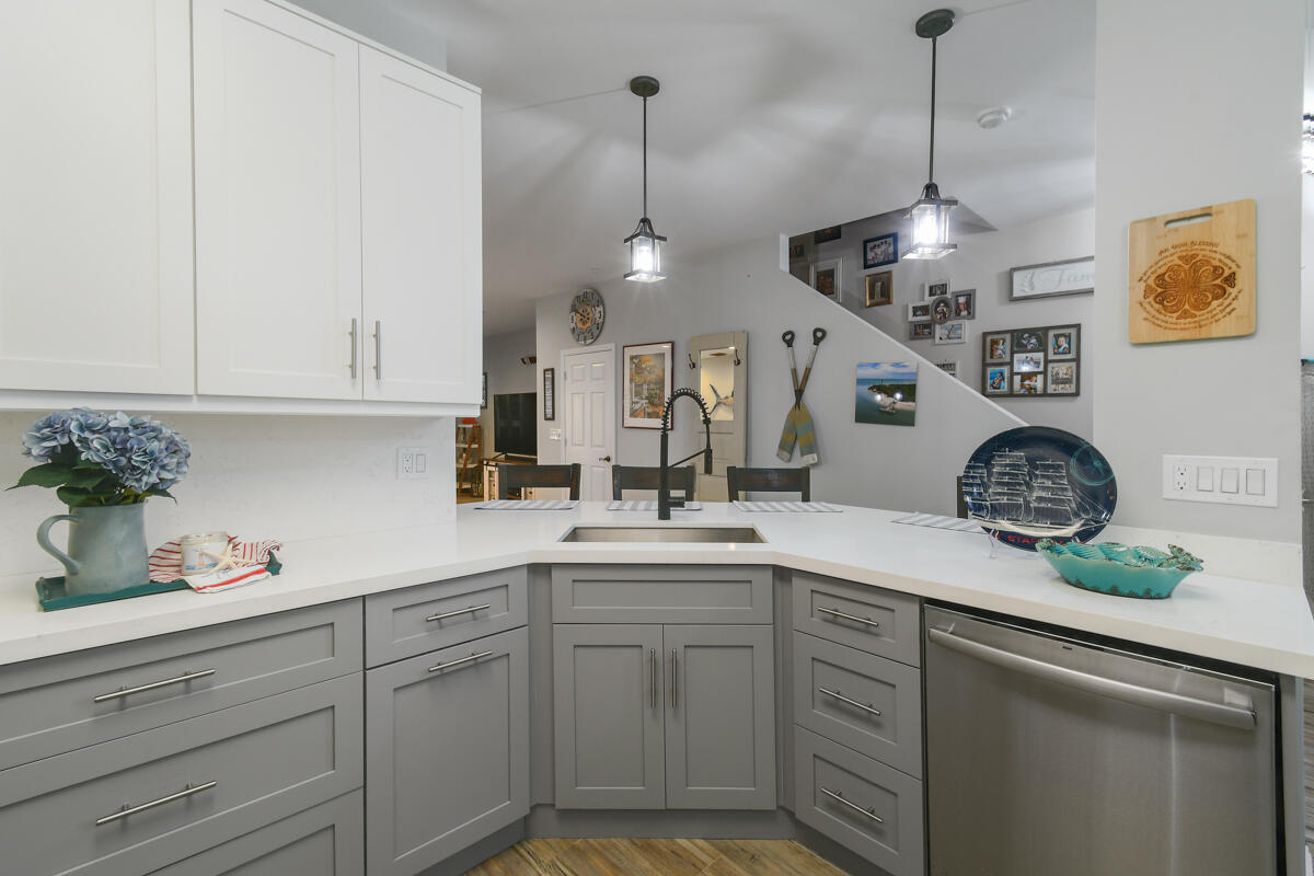 105 Lighthouse Circle, Unit D Tequesta, FL 33469 - Photo 6 of 36 a kitchen with a sink and cabinets