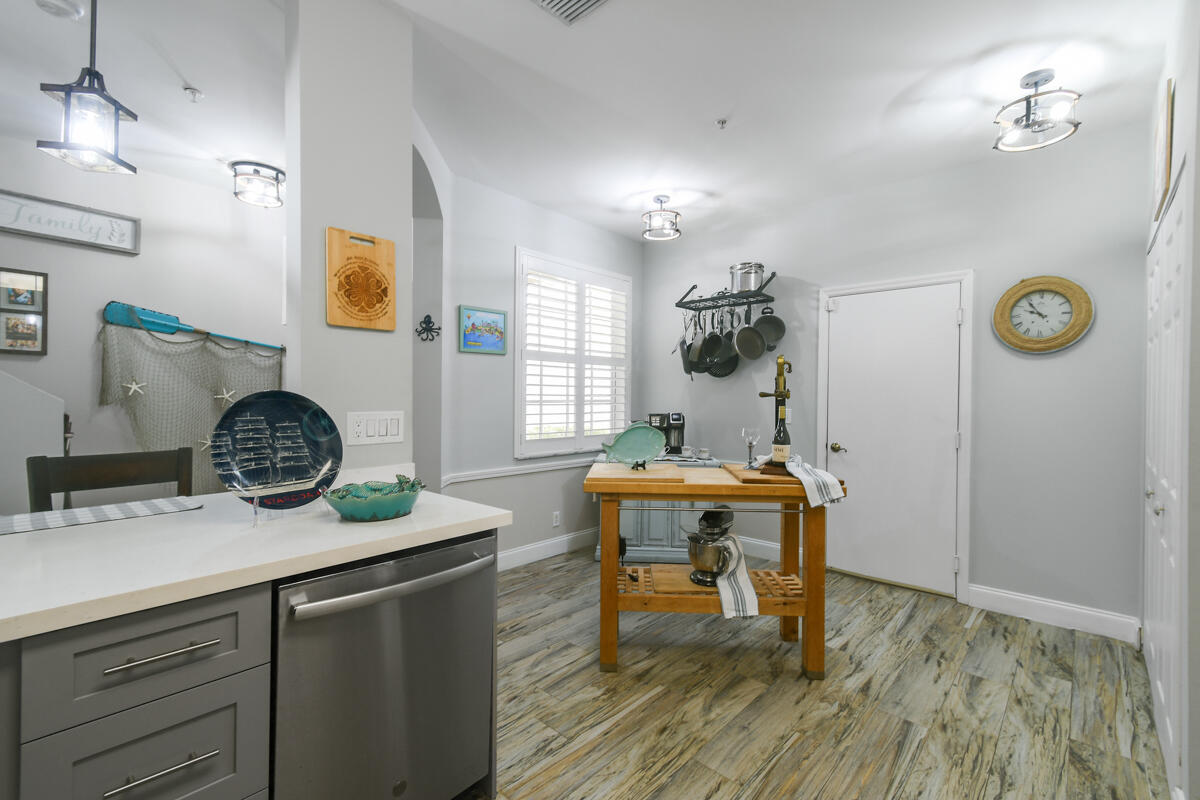 105 Lighthouse Circle, Unit D Tequesta, FL 33469 - Photo 7 of 36 a living room with a table and chairs