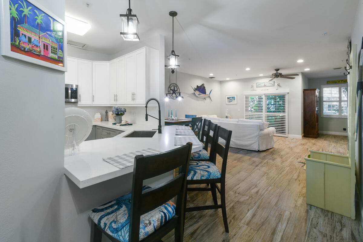 105 Lighthouse Circle, Unit D Tequesta, FL 33469 - Photo 8 of 36 a view of a a dining room with furniture window and wooden floor