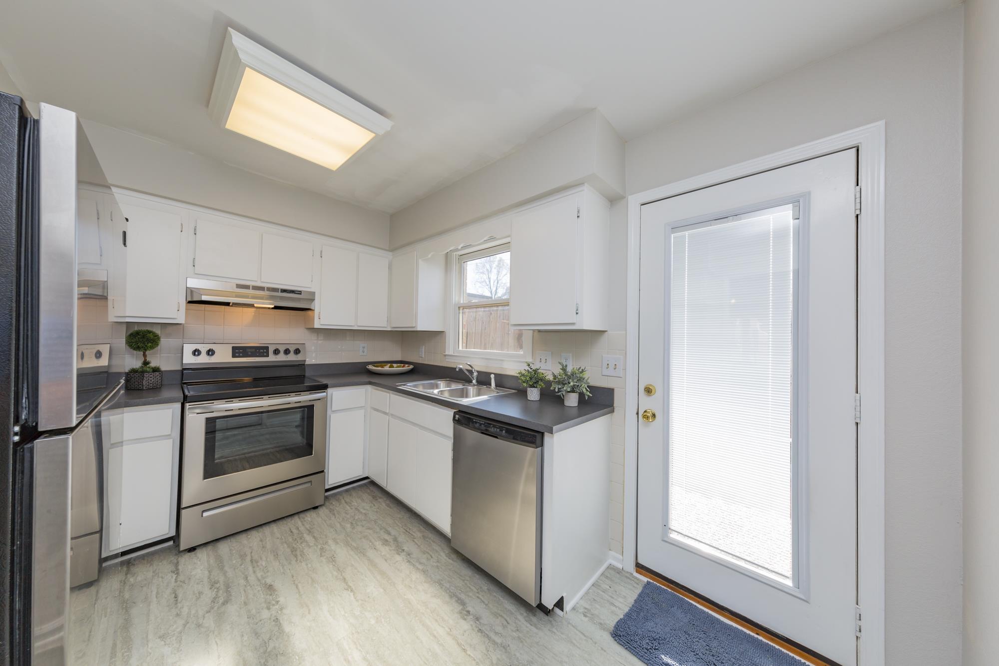 765 Kent Road, Unit 765 Nashville, TN 37214 - Photo 12 of 30 a kitchen with a sink stove and refrigerator